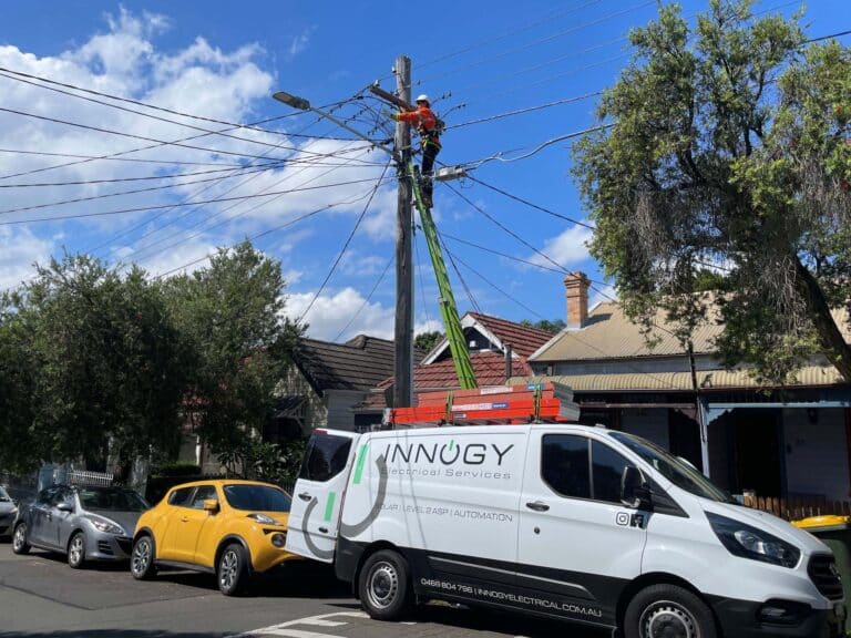 level 2 electrician in Sydney climbing on a utility pole