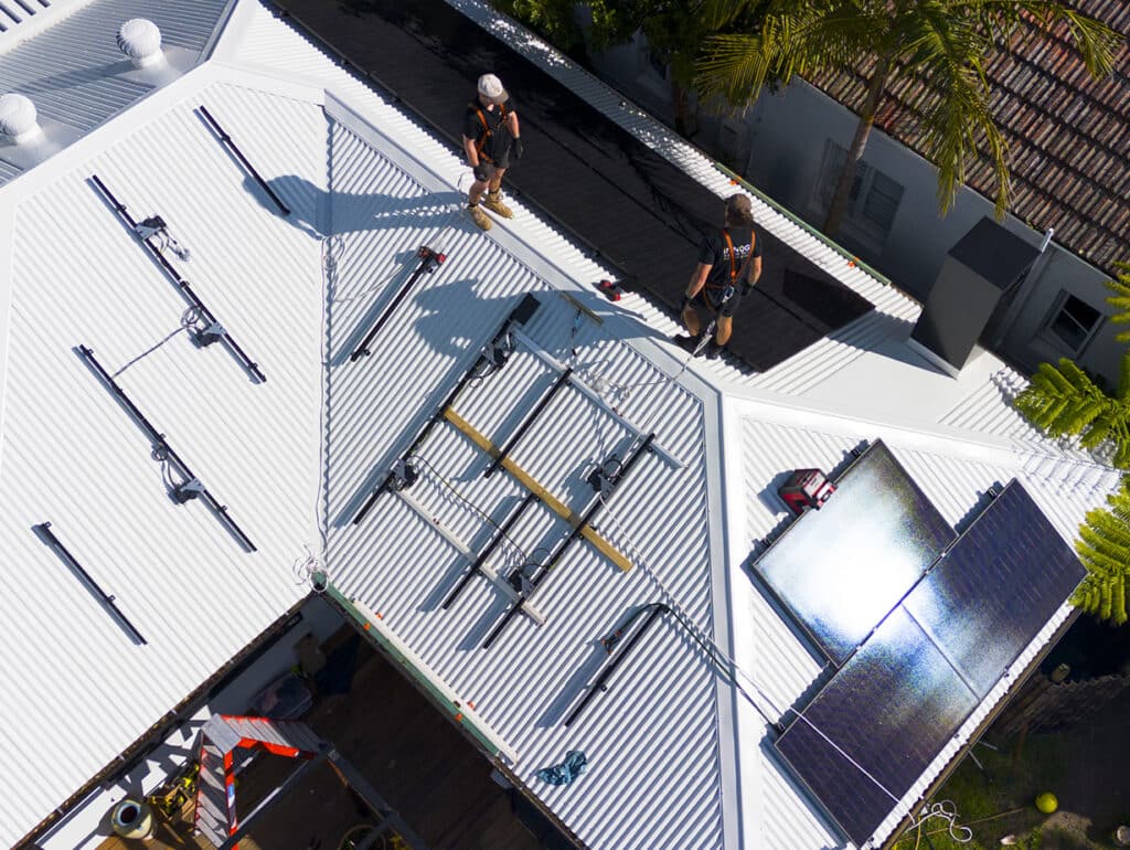 electricians installing solar panels on the roof